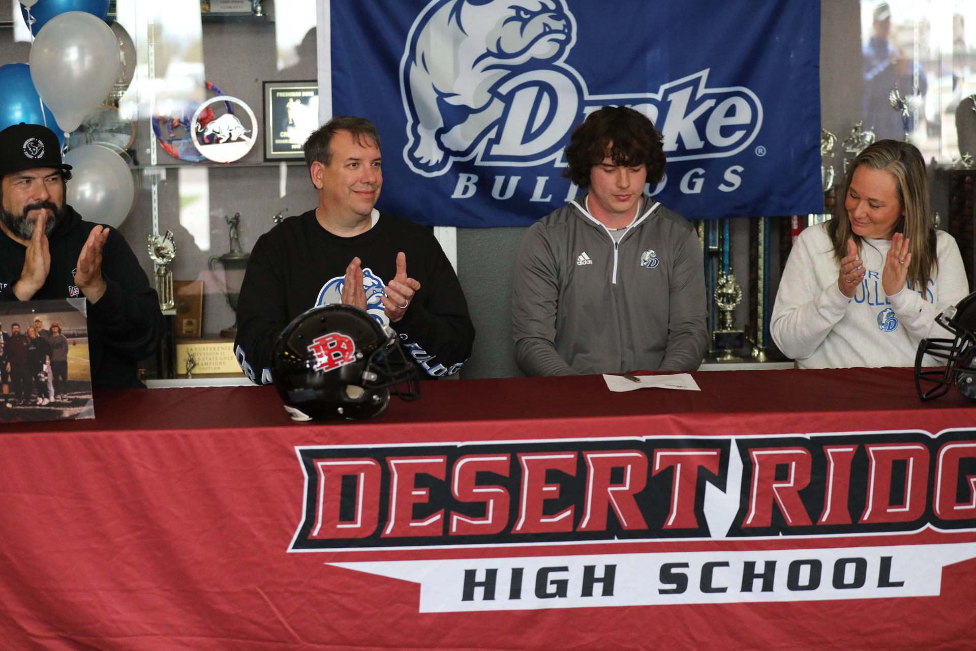 Clapping after he signs with Drake Football