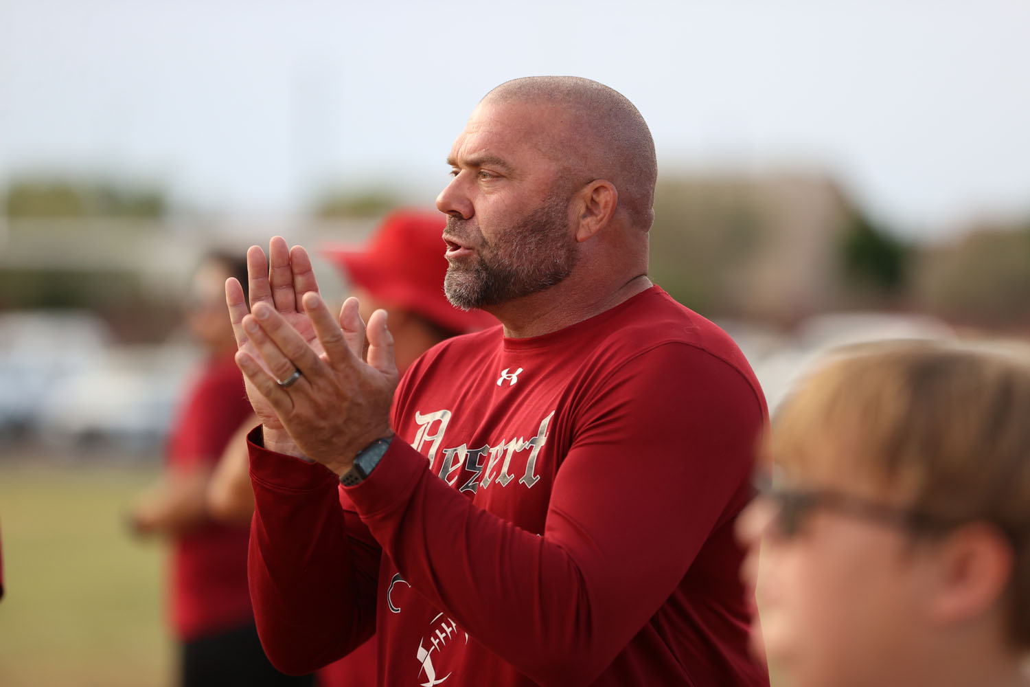 Coach clapping as the squad comes off the field